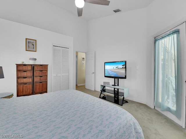 bedroom with light carpet, a closet, and ceiling fan