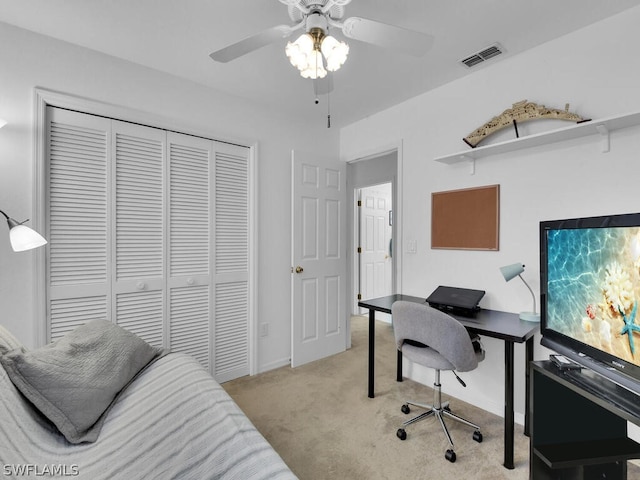 home office featuring light colored carpet and ceiling fan