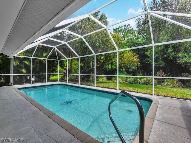 view of swimming pool with a patio and glass enclosure