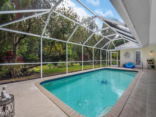 view of pool featuring a patio and glass enclosure