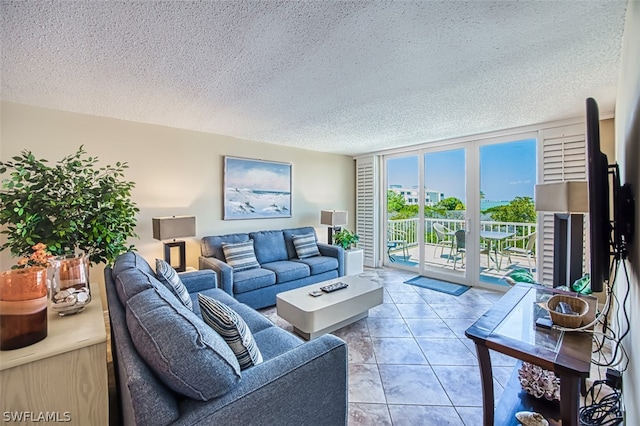 tiled living room with expansive windows and a textured ceiling