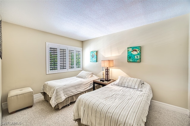 carpeted bedroom with a textured ceiling