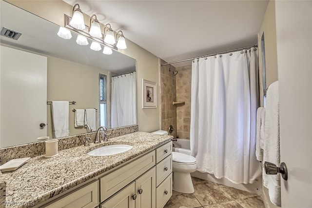 full bathroom with vanity, toilet, tile floors, and shower / bath combo with shower curtain