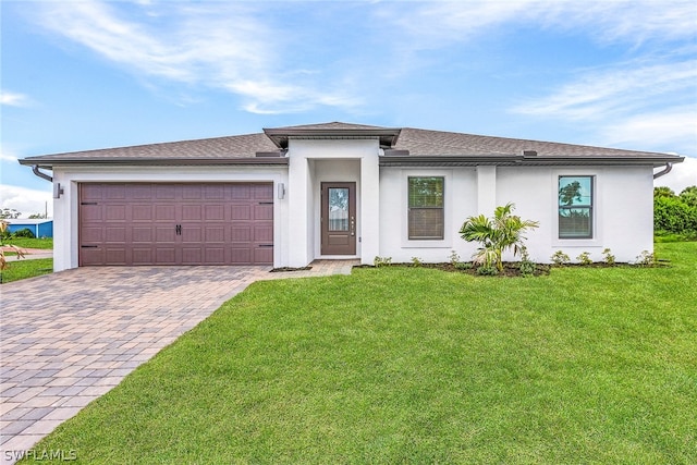 prairie-style home with a garage and a front lawn