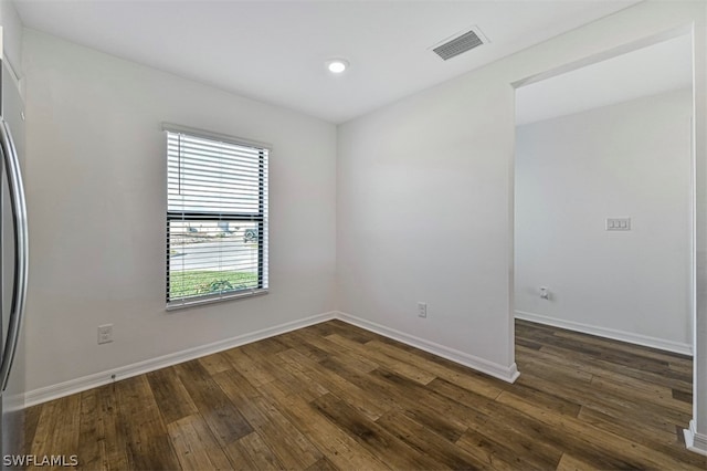 unfurnished room featuring dark hardwood / wood-style flooring