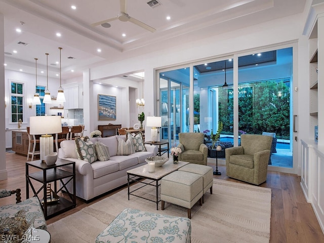 living room featuring ceiling fan and light wood-type flooring