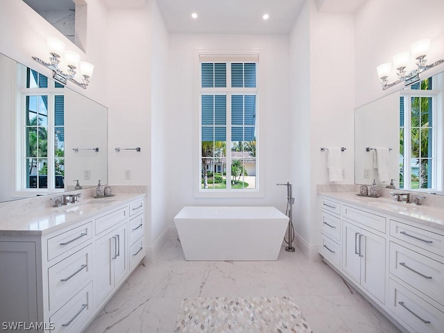 bathroom with a bathtub, plenty of natural light, and vanity