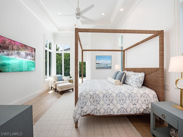 bedroom featuring light hardwood / wood-style flooring, ceiling fan, and ornamental molding