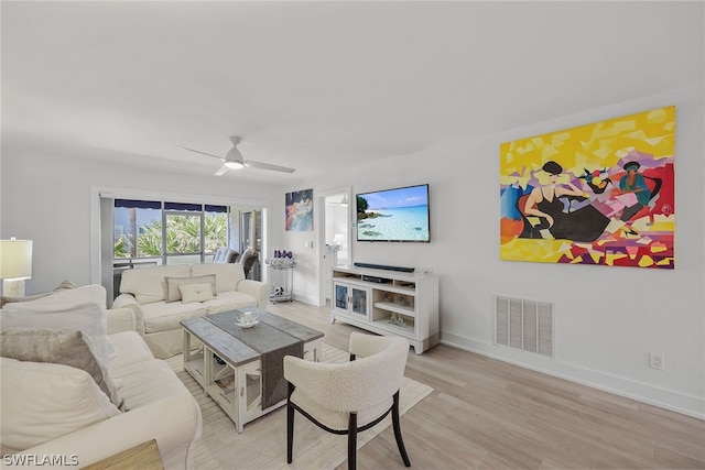 living room featuring light hardwood / wood-style flooring and ceiling fan