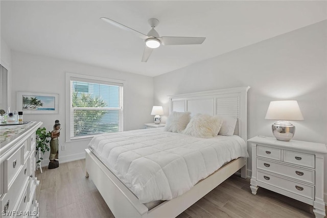 bedroom with ceiling fan and light hardwood / wood-style flooring