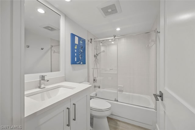 full bathroom with vanity, combined bath / shower with glass door, wood-type flooring, and toilet