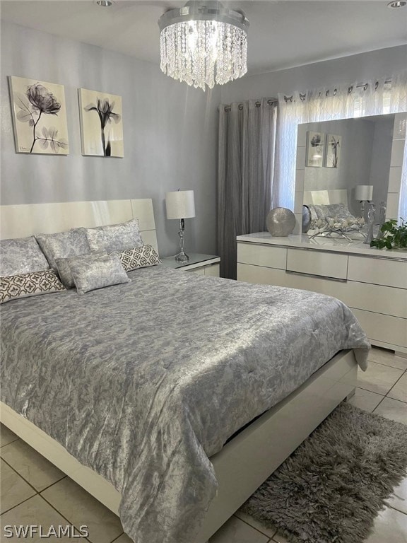 bedroom with light tile floors and a notable chandelier