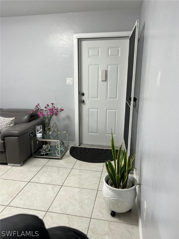 foyer entrance featuring tile floors