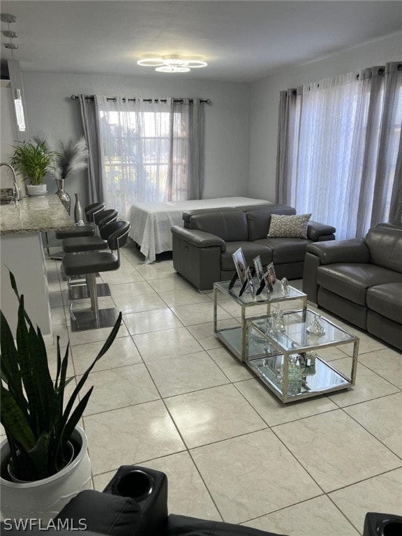 living room with sink and light tile floors