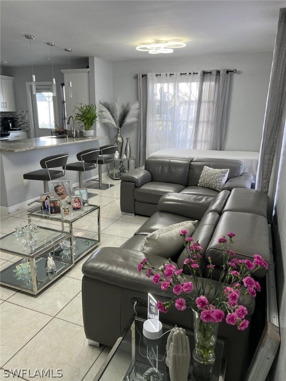 living room featuring sink and light tile floors