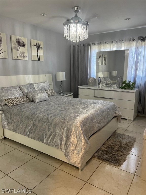 bedroom featuring an inviting chandelier and light tile flooring