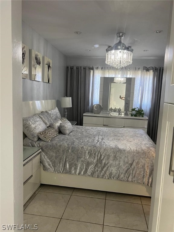 tiled bedroom featuring an inviting chandelier