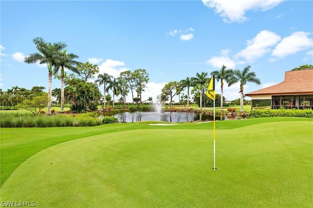 surrounding community featuring view of golf course and a water view