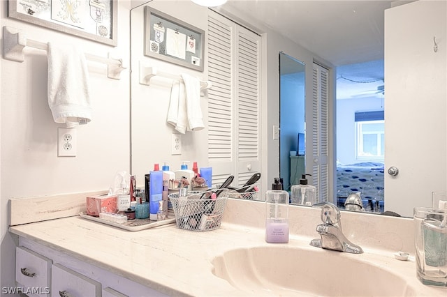 bathroom with vanity, a closet, and ensuite bathroom