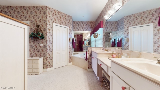 bathroom with a washtub and vanity