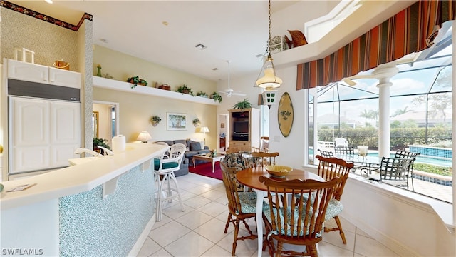 tiled dining space featuring ceiling fan