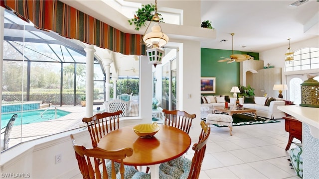 tiled dining room featuring a wealth of natural light and ceiling fan