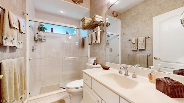 bathroom featuring tile patterned floors, a shower with door, vanity, and toilet