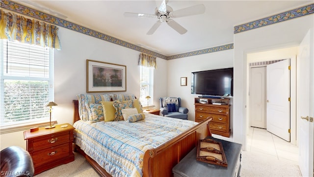 carpeted bedroom with multiple windows and ceiling fan