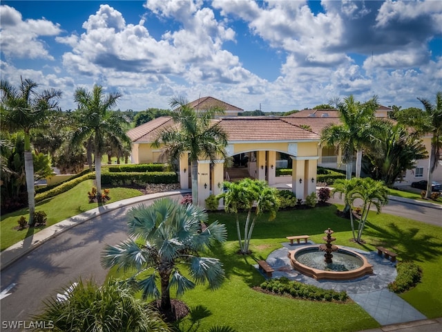 mediterranean / spanish-style house with a front lawn