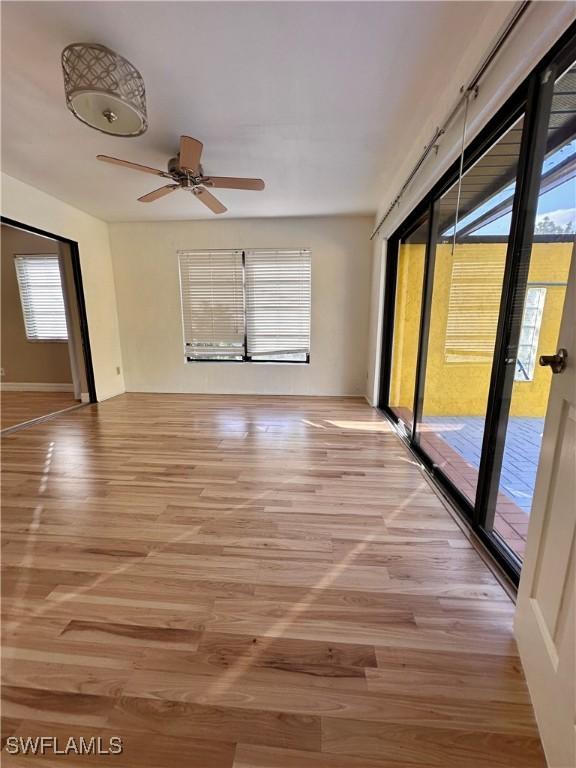 unfurnished room with a wealth of natural light and light hardwood / wood-style flooring