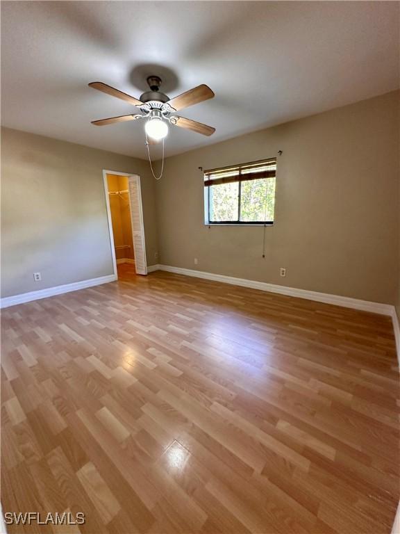 spare room featuring light hardwood / wood-style floors and ceiling fan