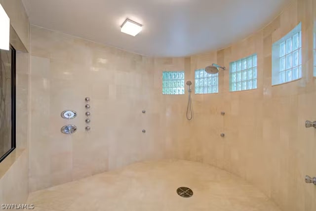 full bath with a tile shower