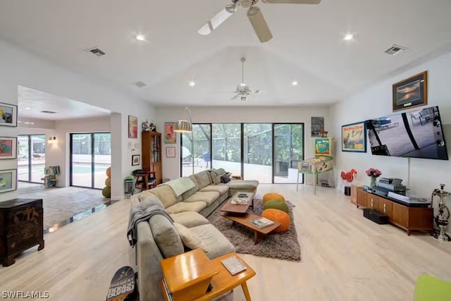 living area with light wood-style flooring, plenty of natural light, and visible vents