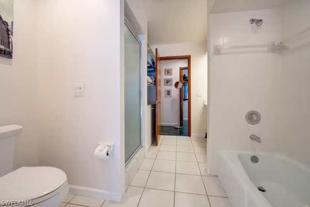 bathroom with a washtub, a shower, toilet, tile patterned flooring, and baseboards