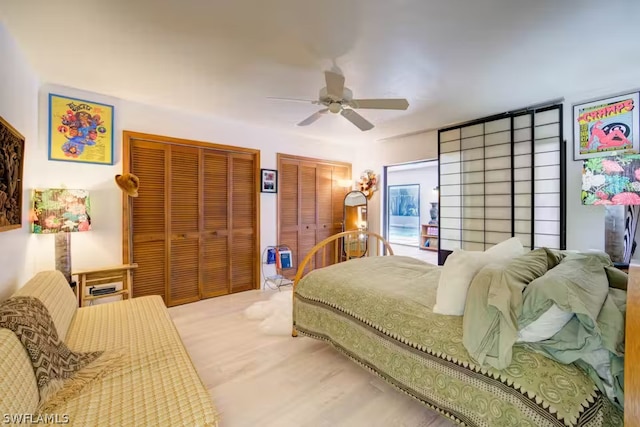 bedroom with two closets and a ceiling fan