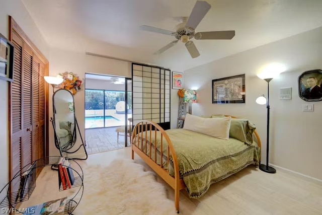 bedroom featuring access to outside, baseboards, ceiling fan, and a closet