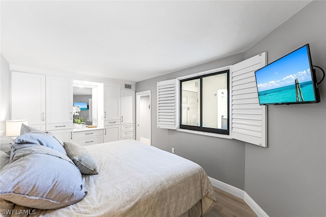 bedroom with hardwood / wood-style floors