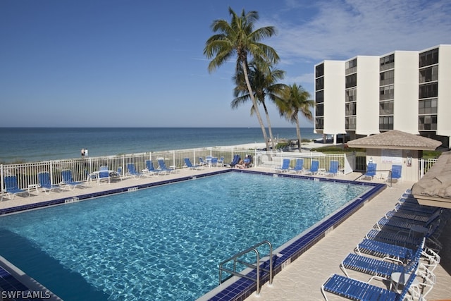 view of swimming pool featuring a water view