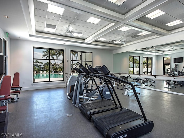 exercise room with a drop ceiling and ceiling fan