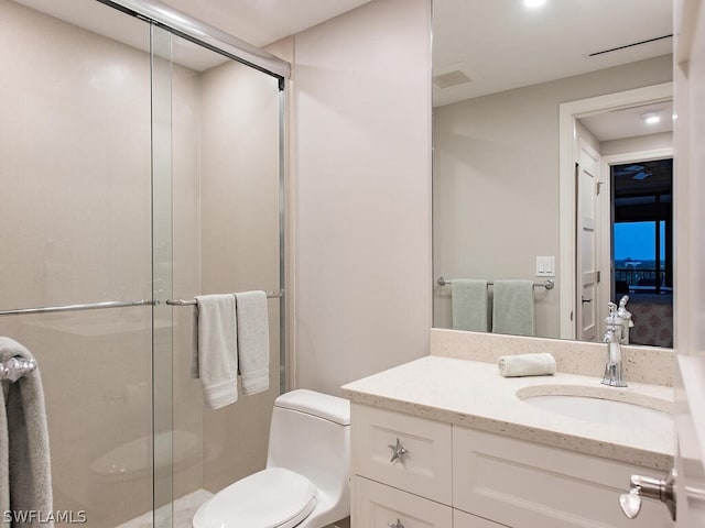 bathroom featuring vanity, toilet, and walk in shower