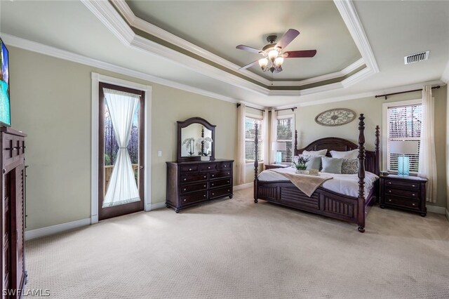 bedroom featuring access to exterior, ceiling fan, light colored carpet, and a tray ceiling