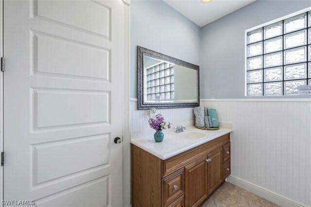 bathroom with tile patterned flooring, vanity, and a wealth of natural light