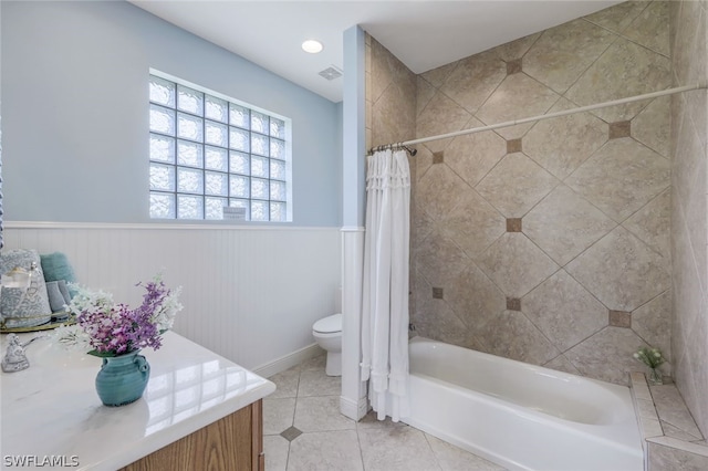 bathroom with tile patterned flooring, toilet, and shower / bathtub combination with curtain