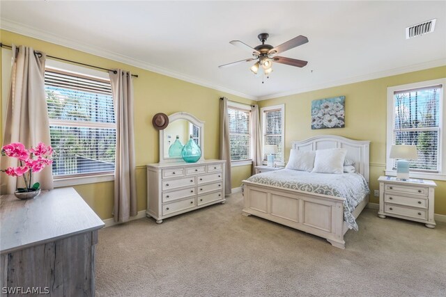 bedroom featuring light colored carpet, multiple windows, and ceiling fan