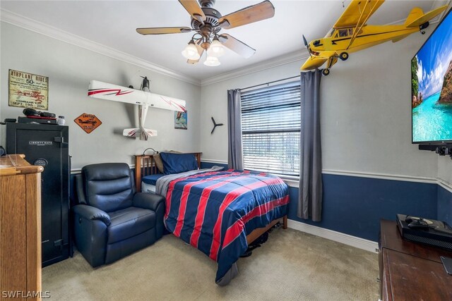 carpeted bedroom featuring ceiling fan and ornamental molding