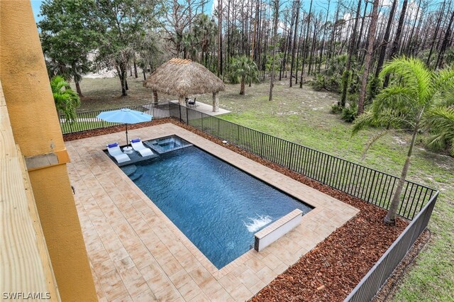 view of swimming pool featuring a lawn, an in ground hot tub, a patio, and a gazebo