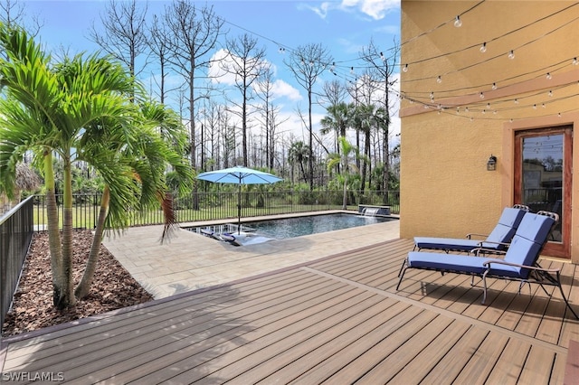 wooden deck featuring a fenced in pool