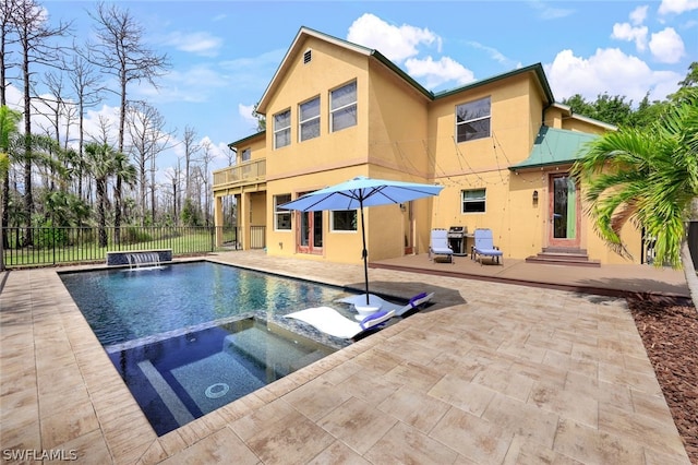 view of pool featuring an in ground hot tub, a patio, pool water feature, and a grill