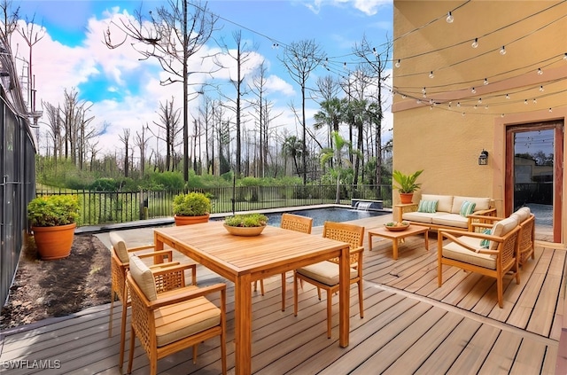 deck featuring a fenced in pool and an outdoor living space