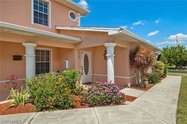 view of exterior entry featuring a porch